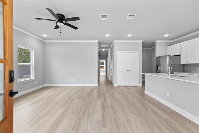 unfurnished living room with light wood-style floors, recessed lighting, visible vents, and baseboards