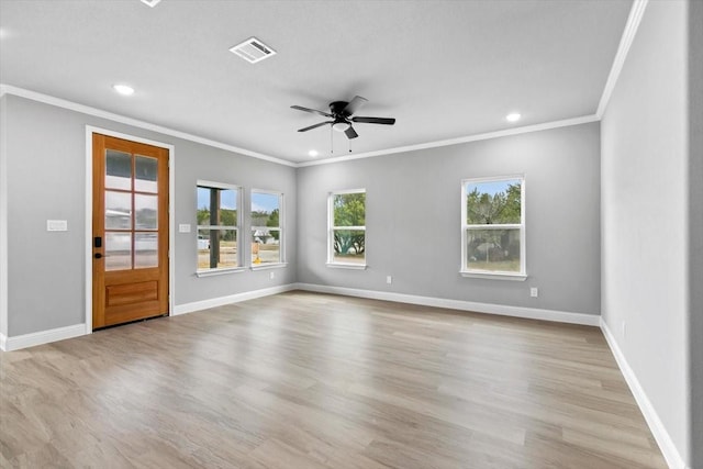 unfurnished room with a wealth of natural light, visible vents, and baseboards