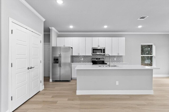 kitchen featuring stainless steel appliances, light wood-type flooring, a sink, and light countertops