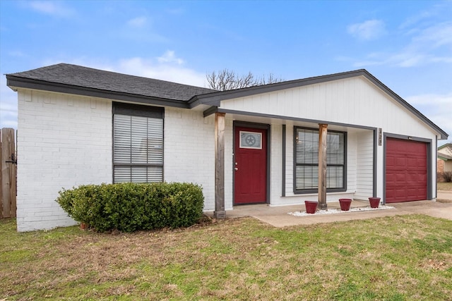 ranch-style house with an attached garage, brick siding, a shingled roof, driveway, and a front yard