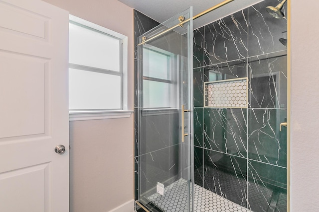 bathroom with a marble finish shower