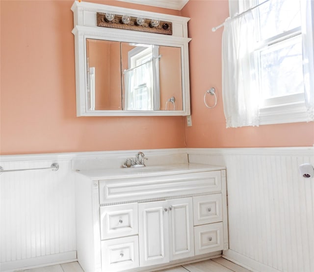 bathroom featuring vanity and a wainscoted wall