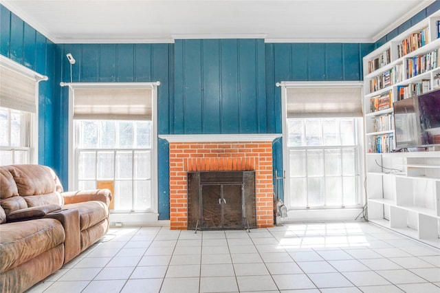 tiled living area featuring a fireplace and ornamental molding