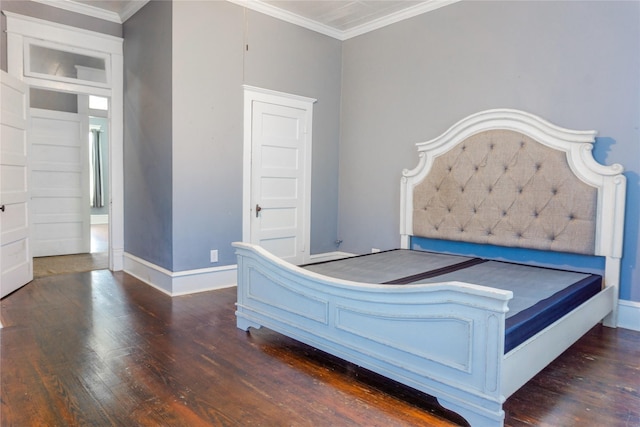 unfurnished bedroom featuring baseboards, wood finished floors, and ornamental molding