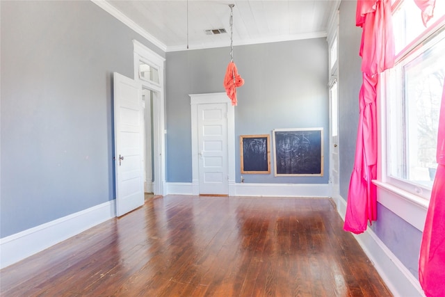 unfurnished living room with a wealth of natural light, baseboards, wood finished floors, and ornamental molding