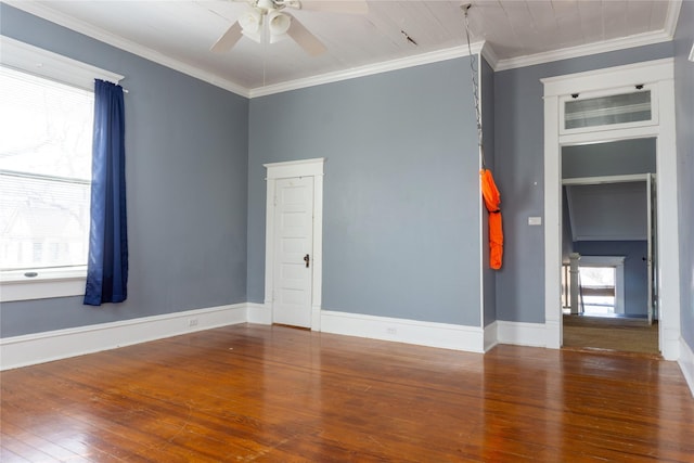 unfurnished room featuring crown molding, hardwood / wood-style flooring, a ceiling fan, and baseboards