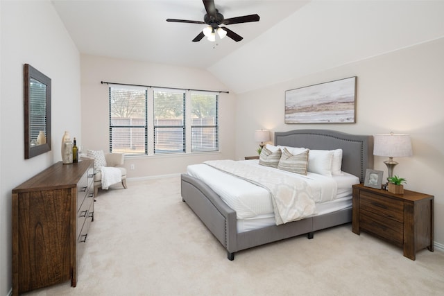 bedroom featuring light carpet, ceiling fan, baseboards, and vaulted ceiling