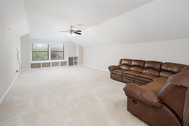 living room featuring baseboards, vaulted ceiling, a ceiling fan, and light colored carpet