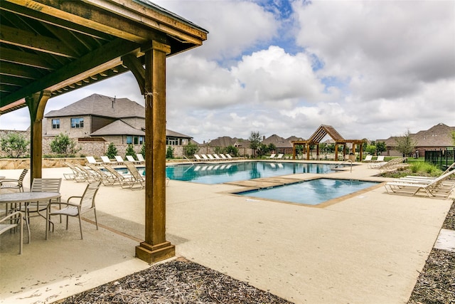 pool featuring a patio, a gazebo, and fence