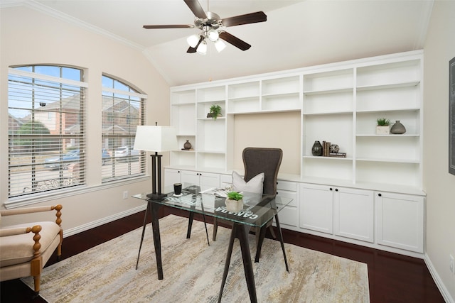 office area featuring lofted ceiling, dark wood-style flooring, a ceiling fan, baseboards, and crown molding