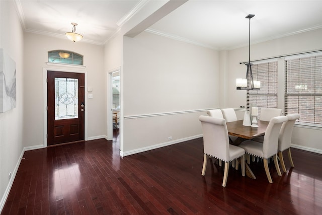 dining room featuring a chandelier, baseboards, crown molding, and hardwood / wood-style floors