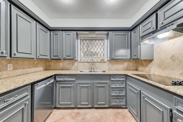 kitchen with gray cabinets, a sink, dishwasher, under cabinet range hood, and black electric cooktop