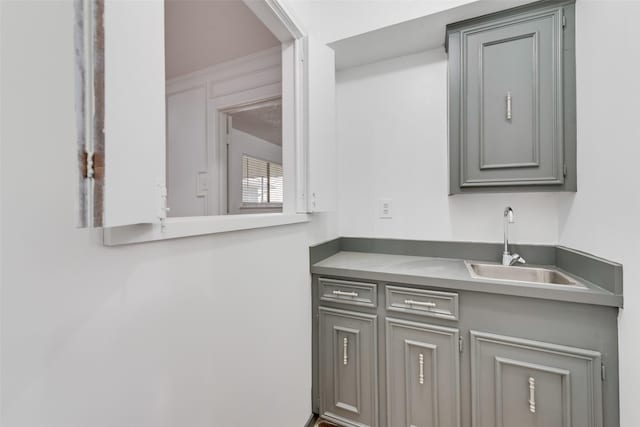 kitchen with gray cabinets and a sink