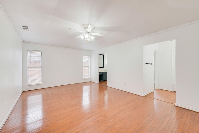 unfurnished room with light wood-type flooring, plenty of natural light, baseboards, and ceiling fan