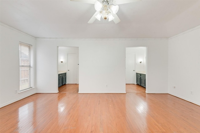 unfurnished room with light wood-style flooring, baseboards, ceiling fan, and ornamental molding