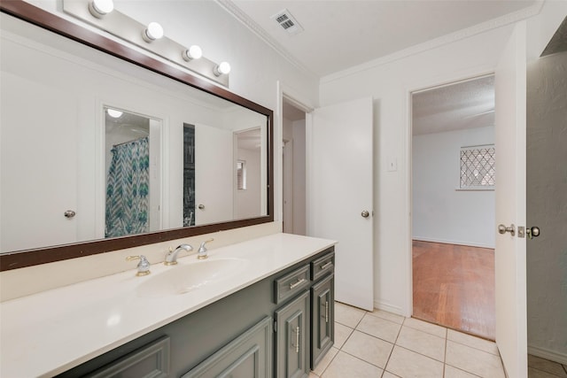 full bath with visible vents, crown molding, vanity, and tile patterned floors