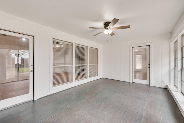 unfurnished sunroom featuring a ceiling fan