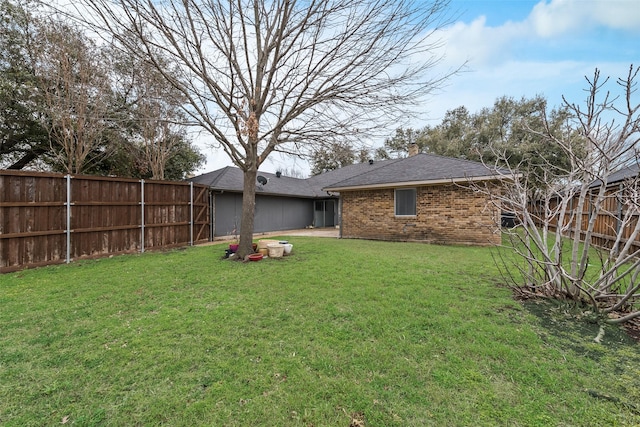 view of yard with a fenced backyard