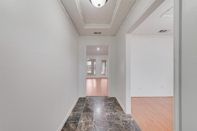 hallway featuring marble finish floor, visible vents, and baseboards