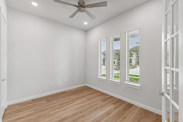 empty room with recessed lighting, light wood-type flooring, and baseboards