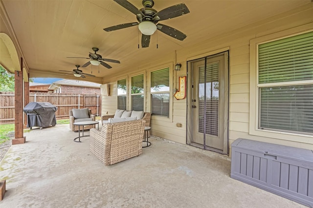 view of patio / terrace featuring fence, an outdoor living space, a ceiling fan, and area for grilling