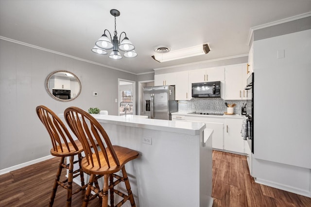 kitchen featuring white cabinets, dark wood-style floors, ornamental molding, light countertops, and black appliances