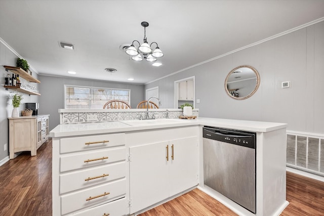 kitchen featuring light countertops, visible vents, ornamental molding, wood finished floors, and dishwasher