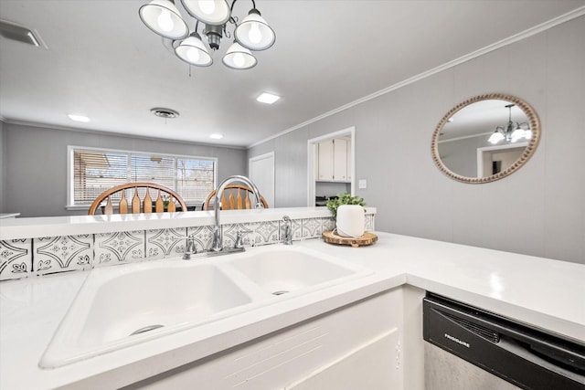 interior space with ornamental molding, a notable chandelier, dishwasher, and a sink