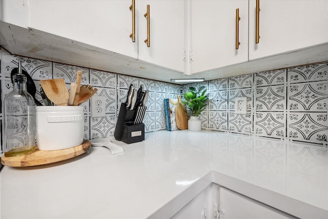 room details with white cabinetry and light countertops