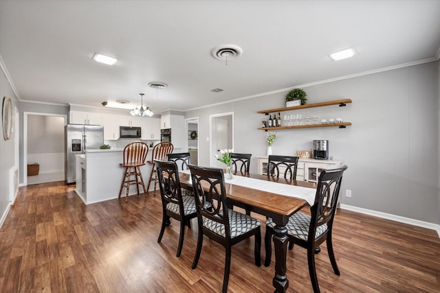 dining area featuring crown molding, visible vents, dark wood-type flooring, a chandelier, and baseboards