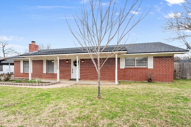 ranch-style house with a shingled roof, brick siding, fence, a front lawn, and a chimney