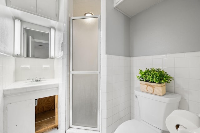 full bathroom featuring toilet, a stall shower, tile walls, and vanity