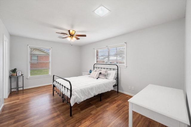 bedroom with wood finished floors, a ceiling fan, and baseboards