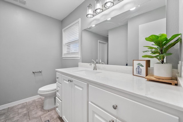 bathroom with tile patterned flooring, toilet, visible vents, vanity, and baseboards