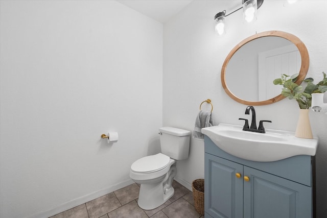 bathroom featuring vanity, tile patterned flooring, toilet, and baseboards