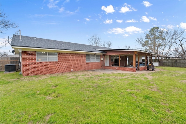 back of house with a yard, fence, a patio, and brick siding