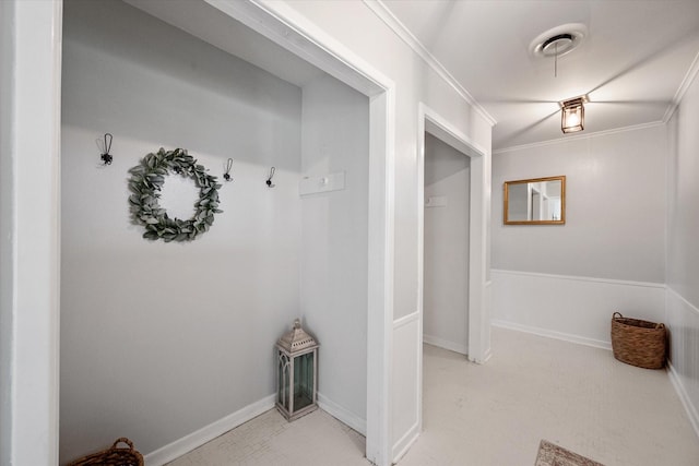 interior space with ornamental molding, visible vents, and baseboards