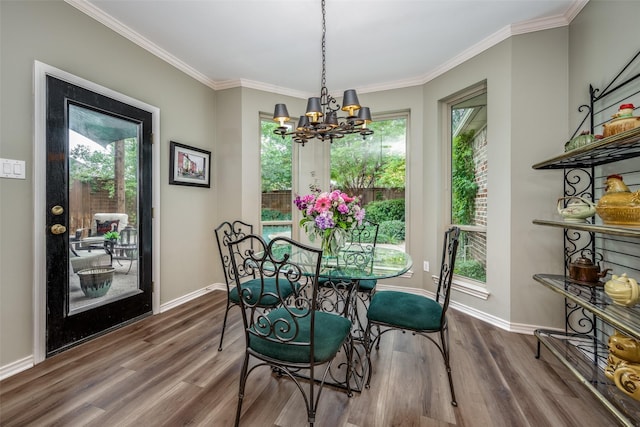 dining area featuring baseboards, wood finished floors, and ornamental molding