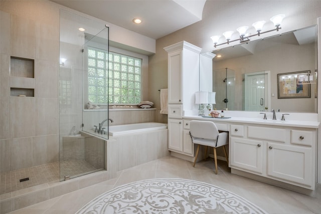 full bath featuring tile patterned flooring, a garden tub, a shower stall, and vanity