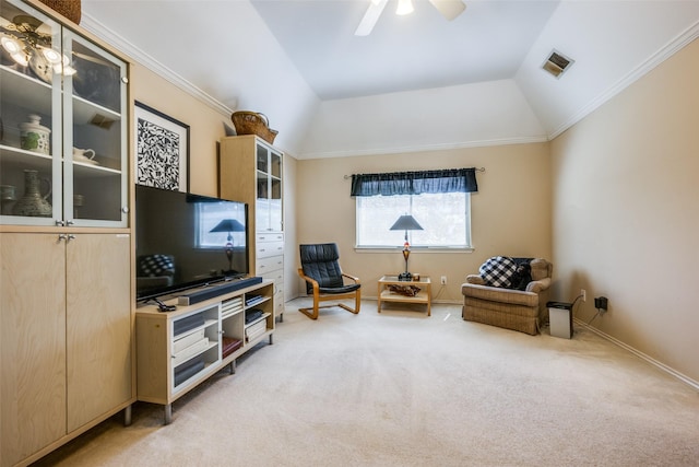 living area with visible vents, baseboards, light colored carpet, lofted ceiling, and ceiling fan