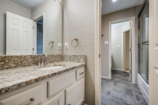 1325 Coral Dr, Coppell, TX 75019 - bathroom with tile patterned floors, bath / shower combo with glass door, and vanity