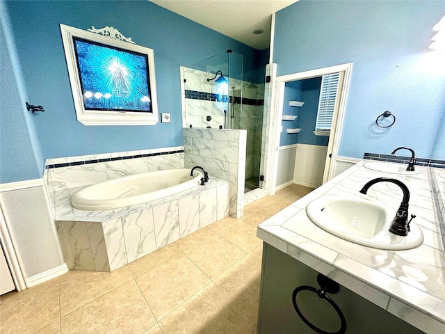 bathroom featuring a stall shower, a garden tub, and tile patterned floors