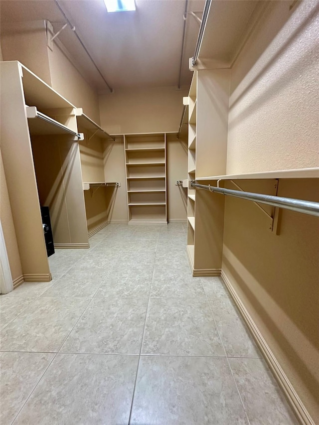 spacious closet with light tile patterned floors