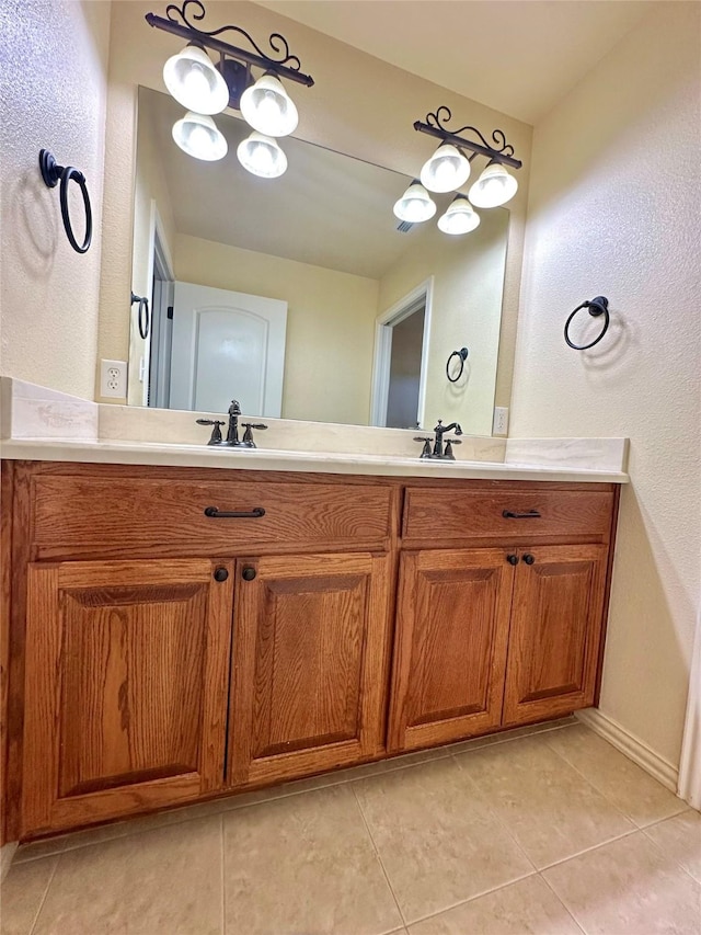 full bath with double vanity, a sink, and tile patterned floors