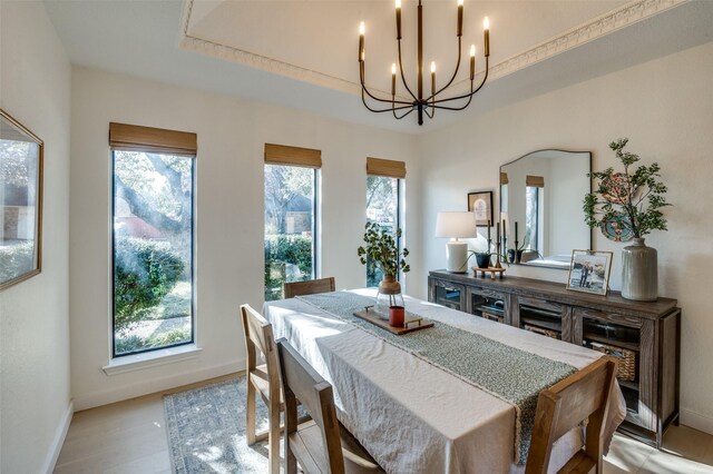 dining area featuring a notable chandelier, light wood finished floors, and a healthy amount of sunlight