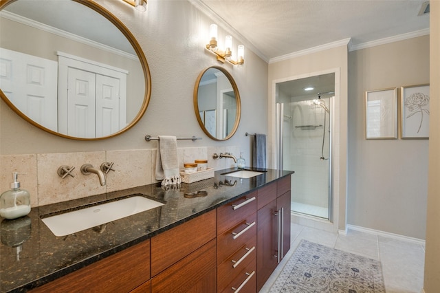 bathroom featuring ornamental molding, a stall shower, and a sink