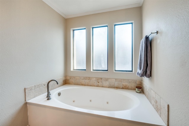 full bathroom featuring a tub with jets, a textured wall, and ornamental molding