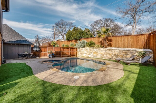 view of swimming pool with a patio area, a fenced backyard, and a pool with connected hot tub