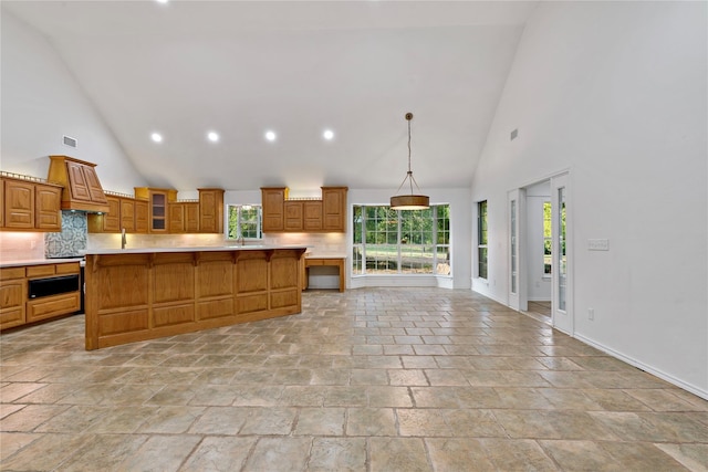 kitchen featuring brown cabinets, light countertops, and plenty of natural light