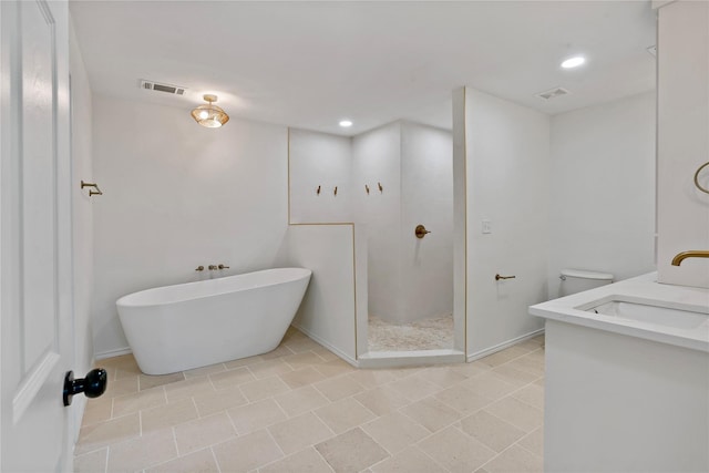 bathroom featuring recessed lighting, a soaking tub, visible vents, and a walk in shower